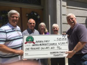 Dearborn Community Foundation Board member Randy Tyler, right, delivers a $1,000 grant check to members of the Aurora First United Methodist Church (from left to right): Roger Fehling, Ken Elder, Ann Elder and Bonnie Nocks. The DCF grant monies are to help the church restore its flood-damaged basement kitchen, which is often used for charitable activities in the community.